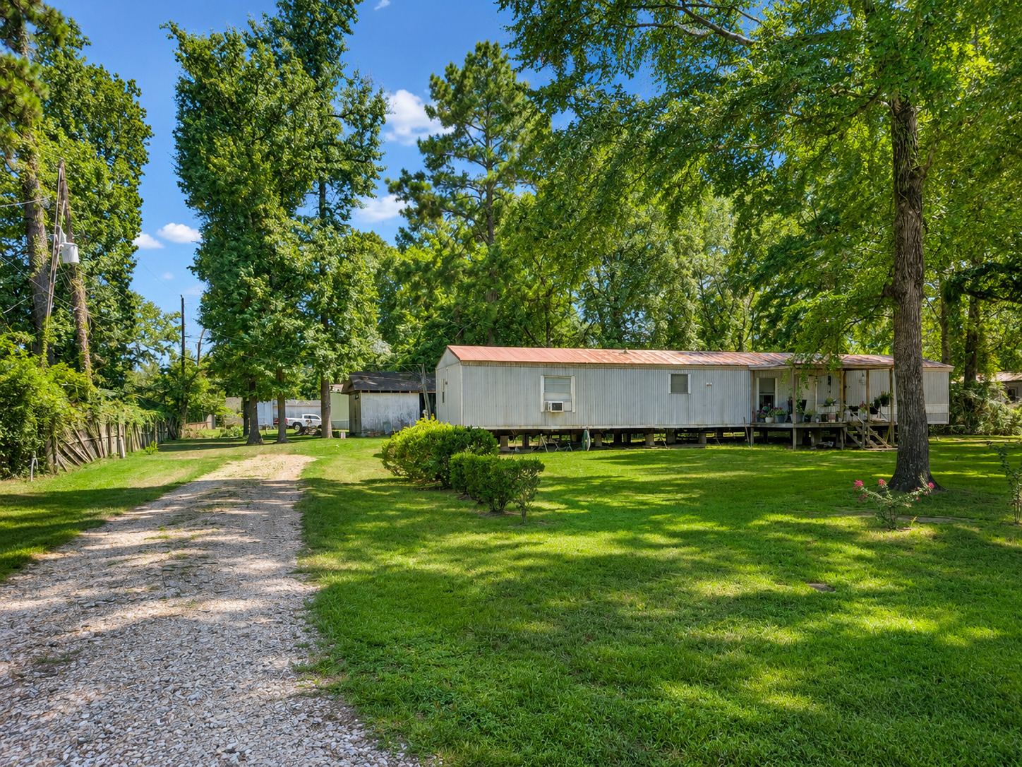 Gravel drive leading to the home across the lawn