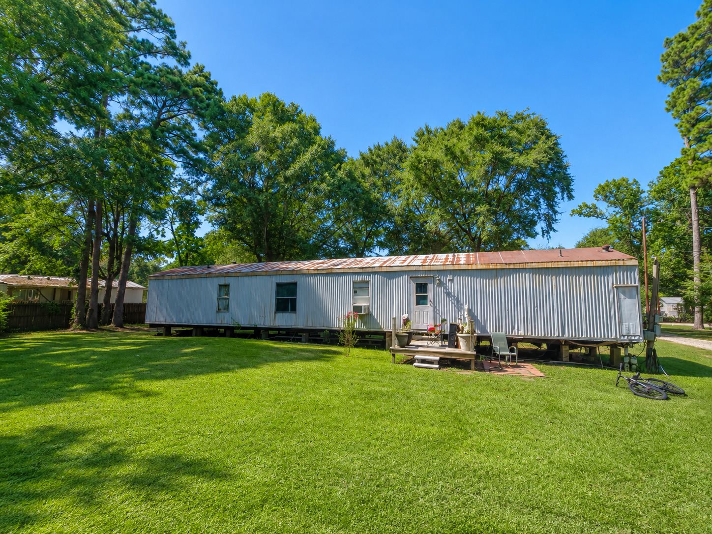 Long side of the home with covered porch and deck