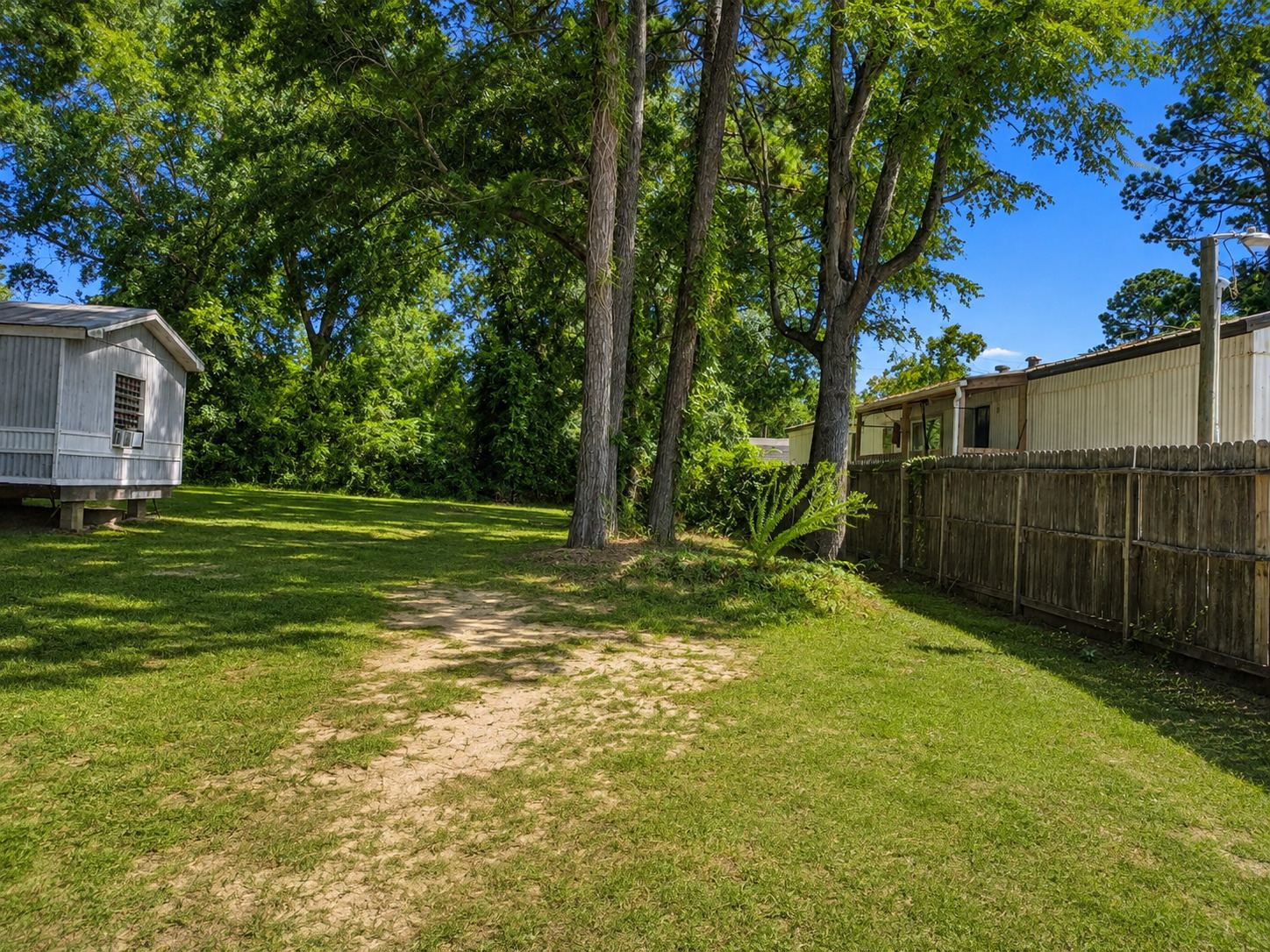 Shaded side path along the fence line